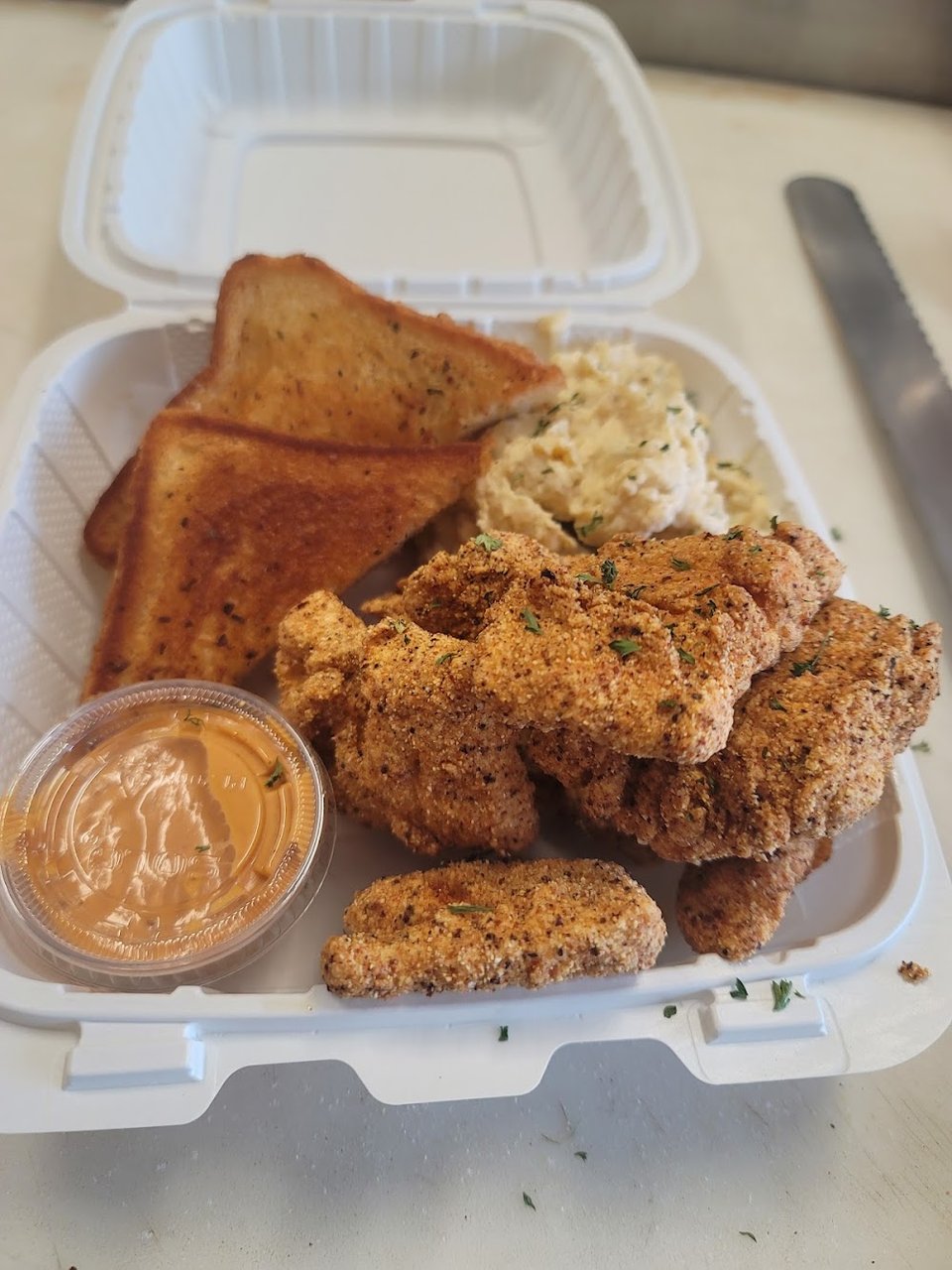 Menu board with Southern classics and seafood plates.