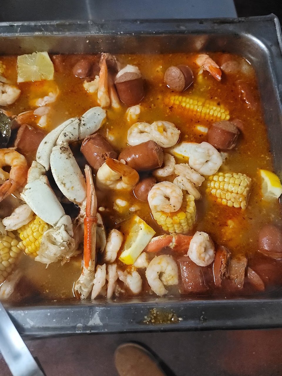 Restaurant menu featuring catfish, oxtails, and mac and cheese.