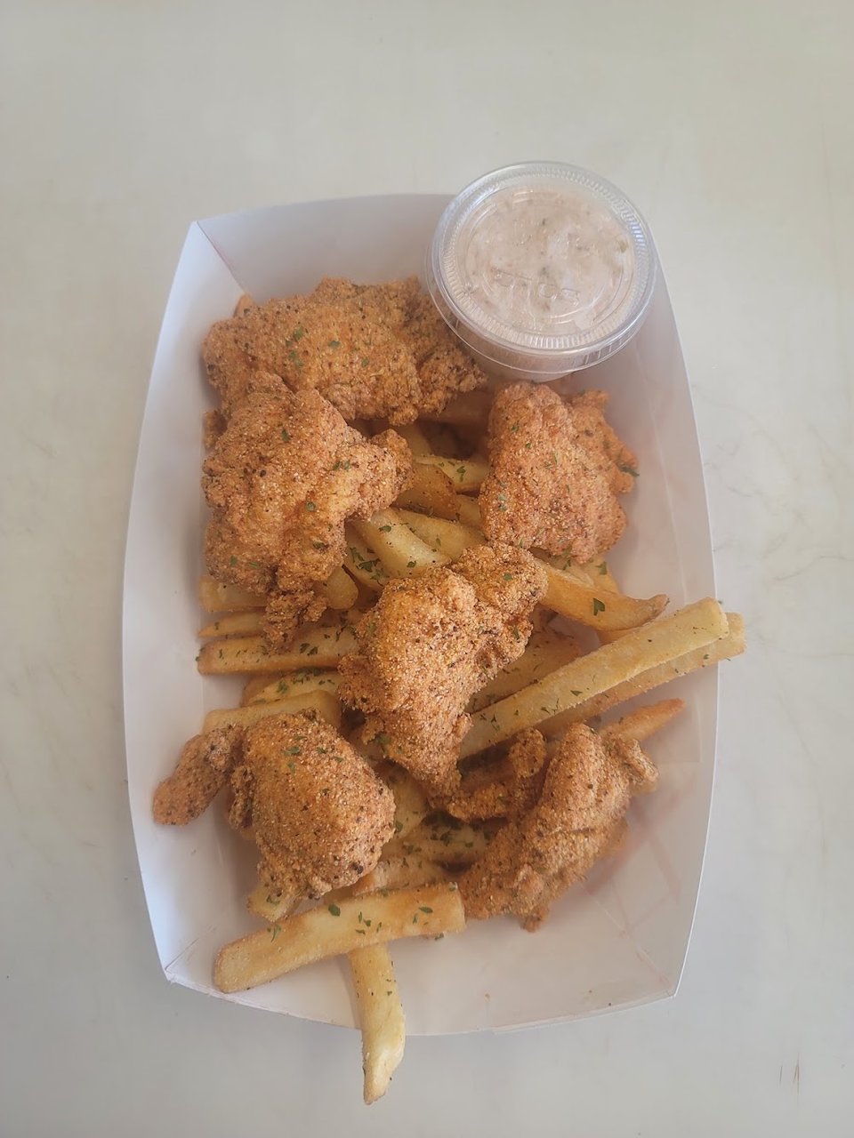 Restaurant menu featuring catfish, oxtails, and mac and cheese.