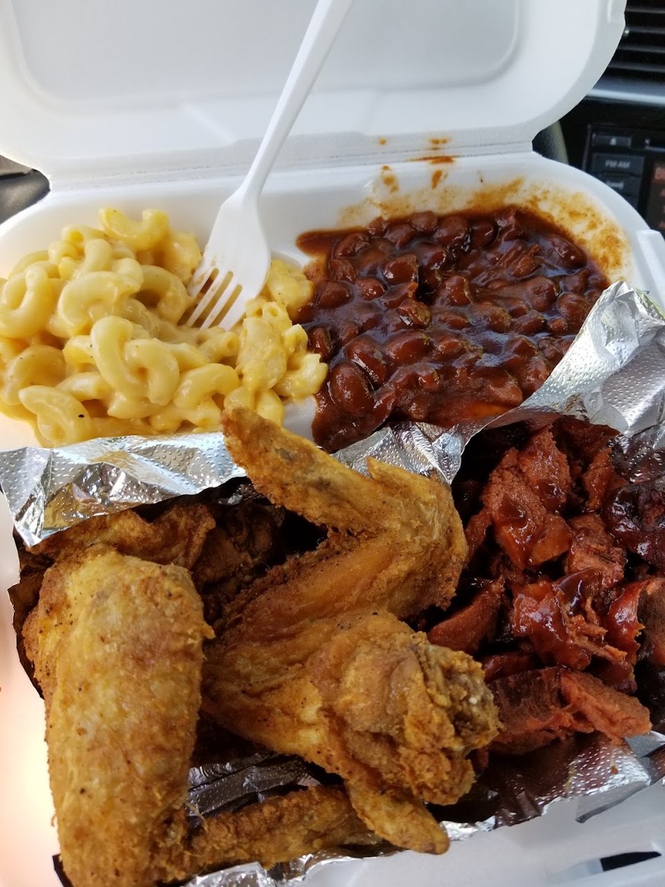 Restaurant menu featuring catfish, oxtails, and mac and cheese.